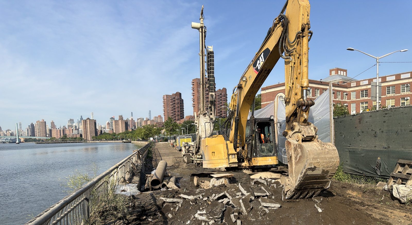 Waterfront construction site along the East River in Manhattan during soil-disturbance activities under a Community Air Monitoring Program
