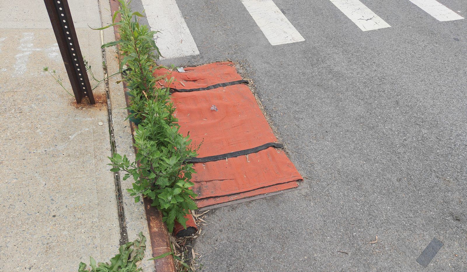 Catch-basin inlet protection: a fabric cover placed over a curbside storm drain inlet to filter sediment from stormwater runoff