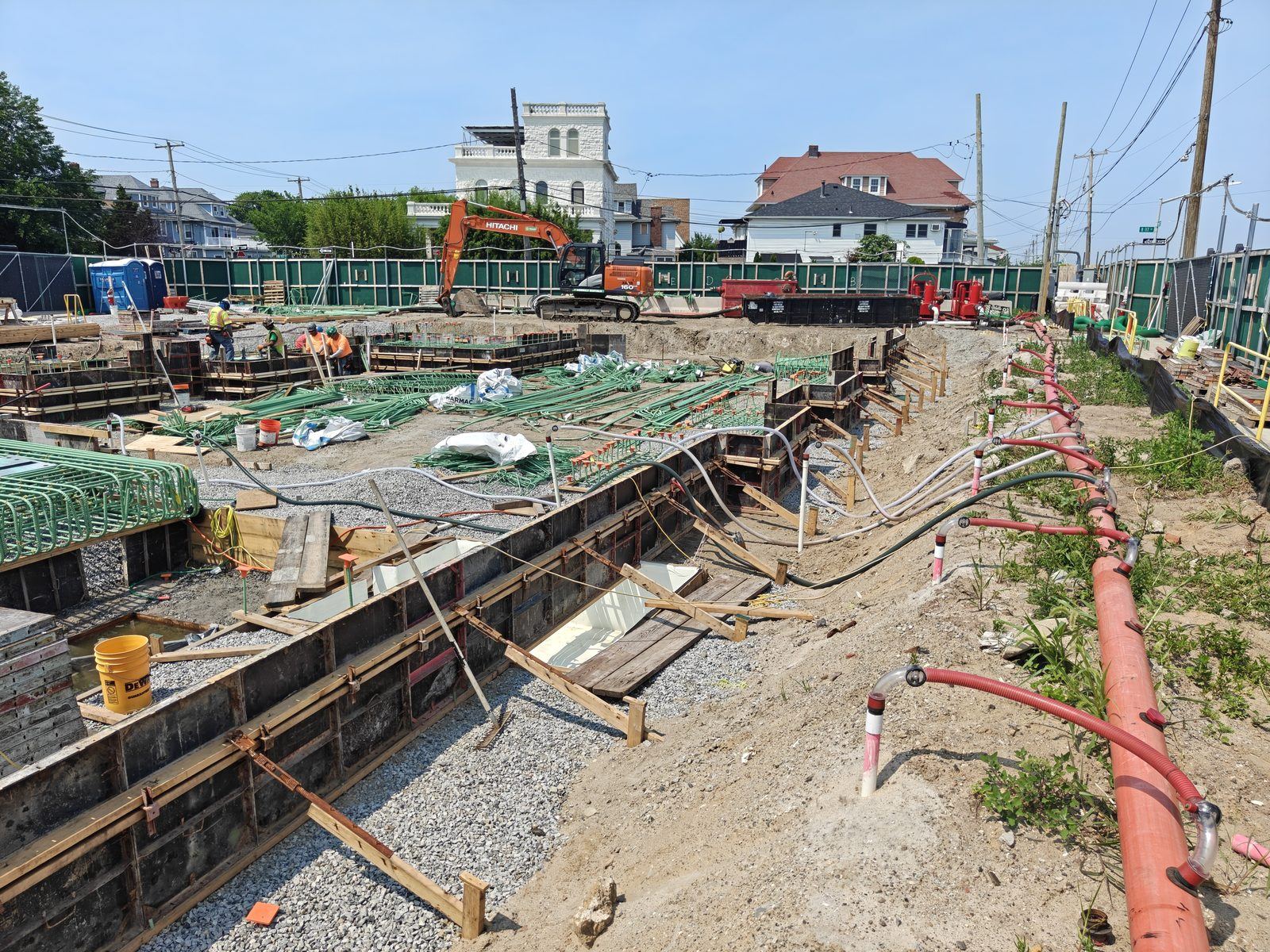 Active New York City construction site with erosion and sediment controls in place, including silt fence, composite silt sock, and pollution-prevention measures, during a Qualified Inspector SWPPP inspection